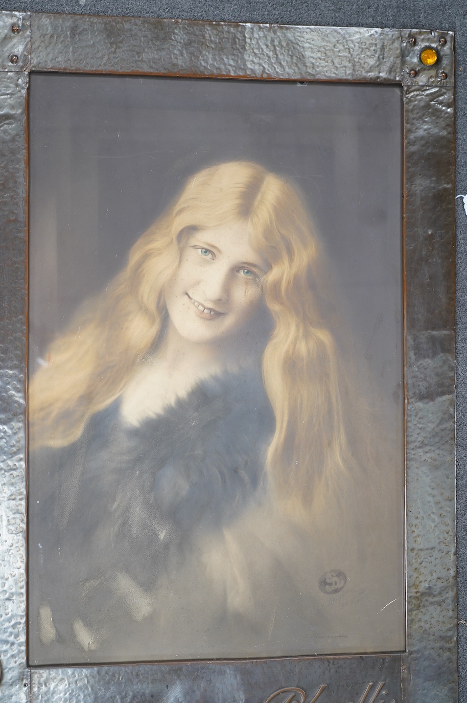 A large Arts & Crafts planished copper frame housing a photograph of Phyllis Dare, an early 20th century actress from Hove, taken by Louis Langfier, overall 100 x 70cm. Condition - fair to good